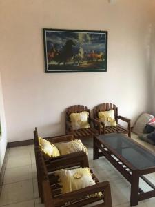 a living room with two chairs and a table at Siti's Guest House in Kalianget