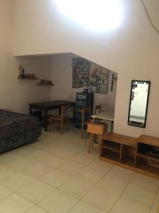 a living room with a table and a dining room at Siti's Guest House in Kalianget