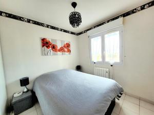 a bedroom with a white bed and a window at Canet-en-Roussillon T3 - 4 pers, CLIM, WIFI, PARKING, Loggia, 3 étoiles - FR-1-794-139 in Canet-en-Roussillon