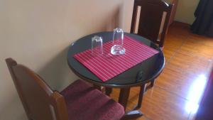 a black table with a red napkin and glasses on it at Hostal GQ in Lima