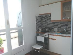 a small kitchen with a sink and a stove at Lilas house in Les Lilas