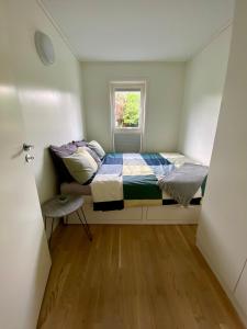 a small bedroom with a bed and a window at Experience a Cozy Getaway Near Pulpit Rock - B unit in Strand
