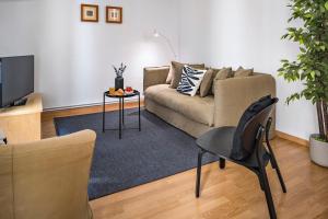 a living room with a couch and a table at Habitat Apartments Art in Barcelona