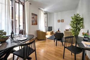 a living room with a dining room table and chairs at Habitat Apartments Art in Barcelona