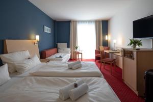 Postel nebo postele na pokoji v ubytování Hotel Mainpromenade ***S