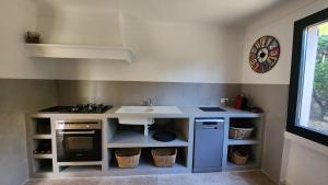 a small kitchen with a sink and a stove at Villa Argonaute in Saint-Tropez