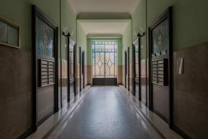 an empty hallway with a door and a window at Casa Romat by Wonderful Italy in Turin