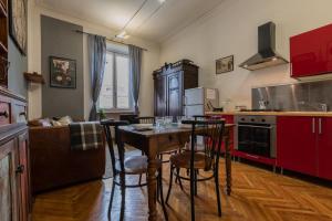 a kitchen with a table and some chairs in it at Casa Romat by Wonderful Italy in Turin +21 photos