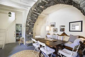 a living room with a table and a couch at Tinos experience the house in Pánormos