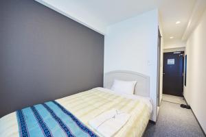 Ένα ή περισσότερα κρεβάτια σε δωμάτιο στο Hotel Peaceisland Naha