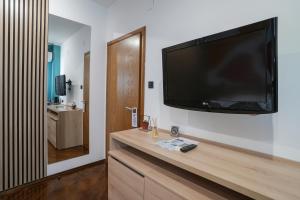 a living room with a large flat screen tv on a wall at 7even weddings & events in Štip