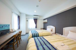 Ένα ή περισσότερα κρεβάτια σε δωμάτιο στο Hotel Peaceisland Naha