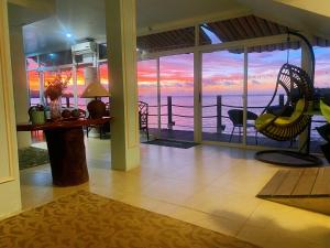 a living room with a view of the ocean at Seaward in Koror