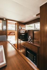 a kitchen with wooden cabinets and a counter top at Classic Yacht I Royal Cruiser 34 - "Barrel" in Klaipėda