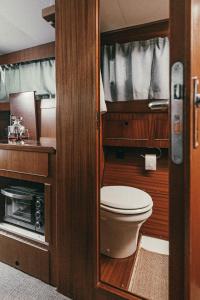 a small bathroom with a toilet and a sink at Classic Yacht I Royal Cruiser 34 - "Barrel" in Klaipėda