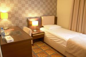 Łóżko lub łóżka w pokoju w obiekcie Hotel Via Baltica