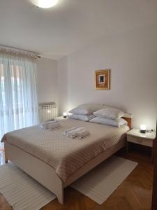 a bedroom with a large bed with two towels on it at Apartment Katarina in Vodnjan