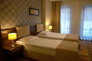 Łóżko lub łóżka w pokoju w obiekcie Hotel Via Baltica