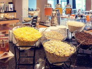 a group of bowls of food on a counter at Mercure Gdańsk Posejdon in Gdańsk