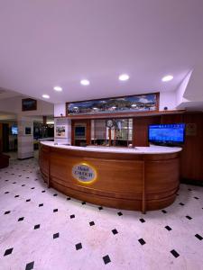 a bar in a restaurant with a large screen at Hotel Cavour in Rapallo