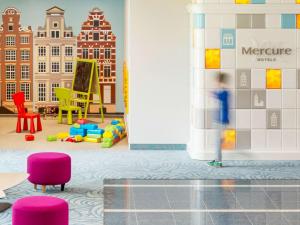 a childrens play room with colorful chairs and a wall at Mercure Gdańsk Posejdon in Gdańsk