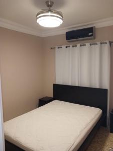 Ένα ή περισσότερα κρεβάτια σε δωμάτιο στο Condominio Leticia 1