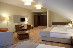 pokój hotelowy z dwoma łóżkami i biurkiem w obiekcie Hotel Via Baltica w mieście Łomża +17 zdjęć