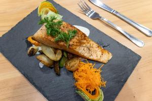a plate of food with fish and vegetables on a table at Hampton By Hilton San Jose Airport Costa Rica in Alajuela City