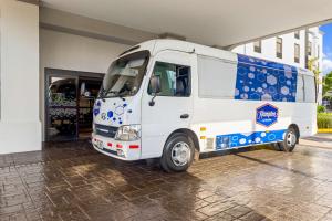 a white van parked in front of a building at Hampton By Hilton San Jose Airport Costa Rica in Alajuela City