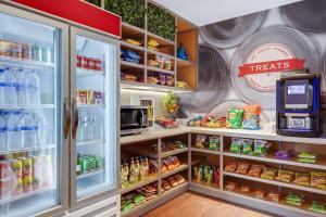 a refrigerator filled with lots of drinks and food at Hampton By Hilton San Jose Airport Costa Rica in Alajuela City