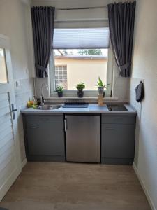 a kitchen with a sink and a window at Harz-Stübchen in Wernigerode