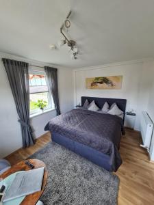 a bedroom with a bed and a table with a laptop at Harz-Stübchen in Wernigerode