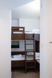 a bunk bed with a ladder in a room at H&ocirc;tel & Appartements Monsigny in Nice