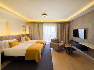 a hotel room with two beds and a flat screen tv at Dugi in Istanbul