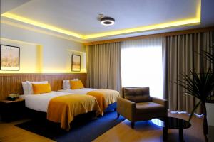 a hotel room with a bed and a chair at Dugi in Istanbul