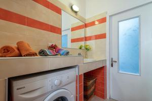 a bathroom with a washing machine and a sink at Magic Sea View Borgo Castelsardo in Castelsardo