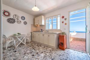 a kitchen with a sink and a table at Magic Sea View Borgo Castelsardo in Castelsardo +18 photos