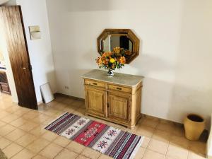 a vase of flowers on a dresser in a room at Ca na moltona in Ses Salines