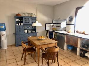 a kitchen with a wooden table and chairs in a kitchen at Ca na moltona in Ses Salines +17 photos