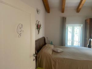 a bedroom with a bed and a window at Finale Ligure Gorra Rooms Rosa di Mare vicino al mare lontano dal caos! in Borgio Verezzi
