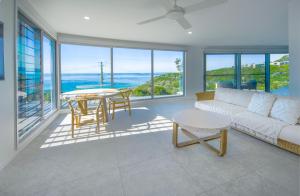 a living room with a couch and a table at Coolum luxury apartment with king bed and ocean views in Coolum Beach +7 photos