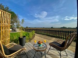 a patio with two chairs and a table with two drinks at Silo Blue in Great Dunmow