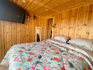 a bedroom with a bed in a wooden room at Silo Blue in Great Dunmow