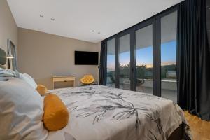 a bedroom with a large bed and a large window at Villa She Luxury by IstriaLux in Grožnjan +51 photos