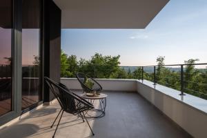 two chairs on a balcony with a view at Villa She Luxury by IstriaLux in Grožnjan