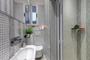 フィレンツェにあるConce Apartment by Mamo Florenceの洗面台とトイレを備えた白いバスルーム