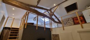 a room with a large window and a staircase at O Beaujolais Chiroubles in Chiroubles