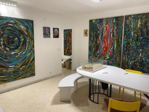a room with some paintings on the walls at La Casa dell'Architetto in Bari