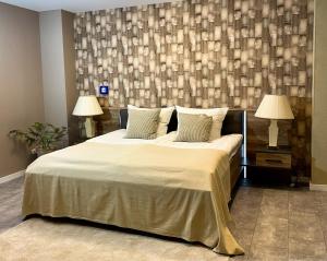 a bedroom with a large bed with two lamps at Komfort Zone in Wolfsburg