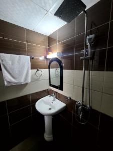 a bathroom with a sink and a mirror at Furnished Luxury 2-bedroom apartment -Vanguard X ,Cloud 9 in Douala